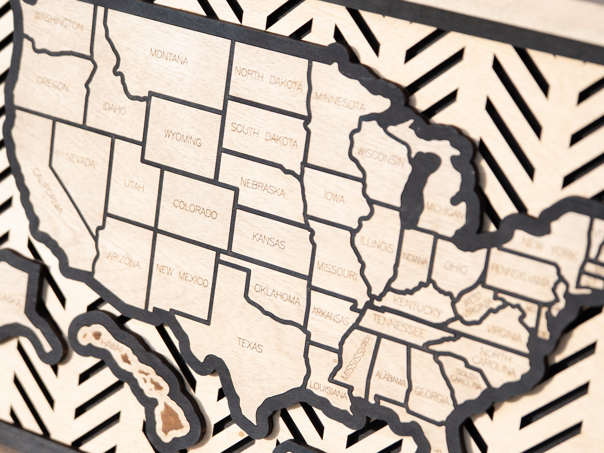 Hand-finished Hearthline Series wooden USA travel map with engraved state outlines and chevron patterned backdrop, showcasing premium craftsmanship.