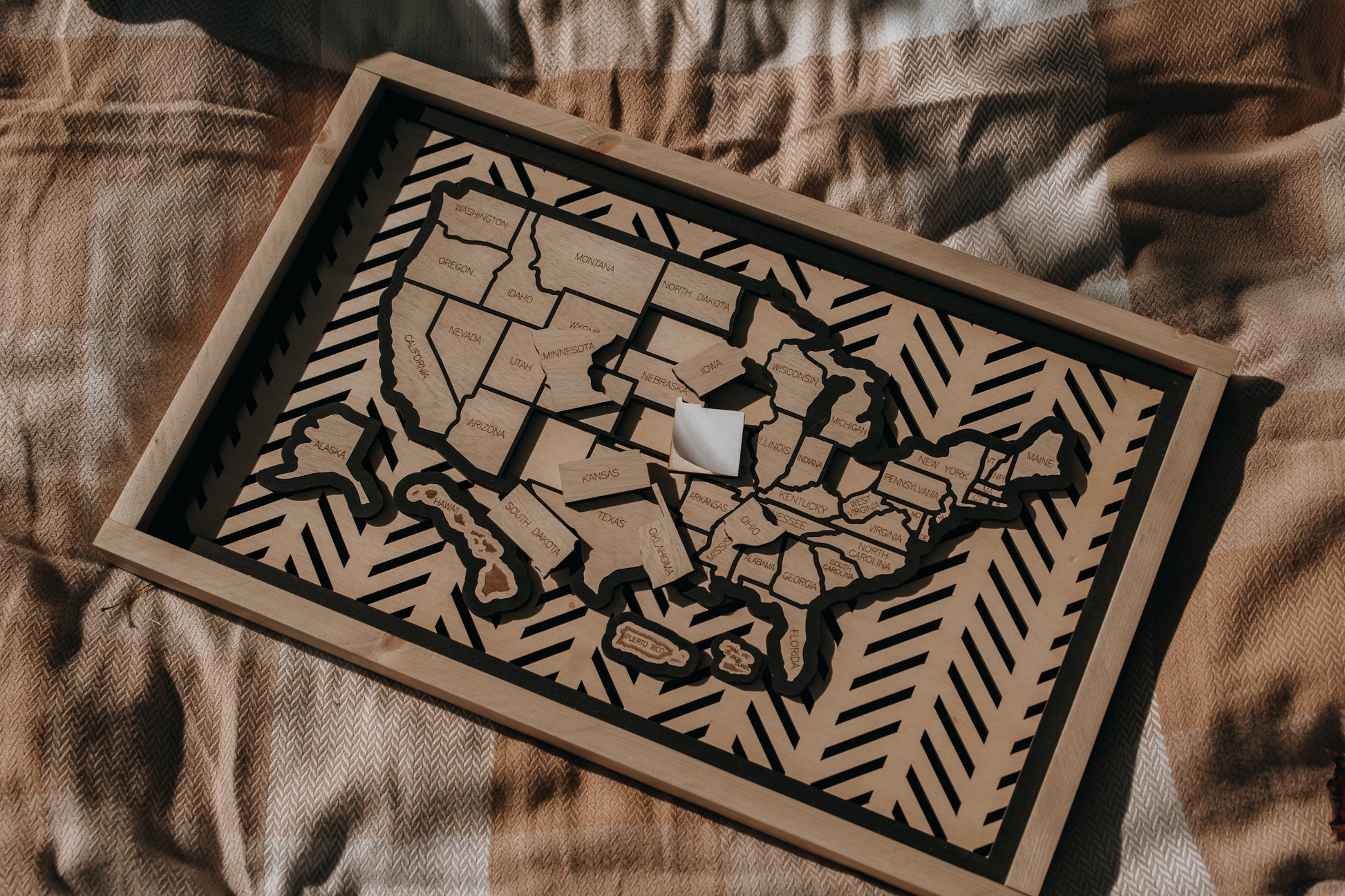 Hearthline Series wooden USA map showing peel-and-stick state pieces ready to place, designed for tracking travel memories one state at a time.