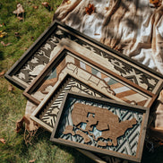 Handcrafted wooden USA travel maps in four sizes — Essential, Signature, Collector’s, and Heirloom — displayed together to show scale and detail.