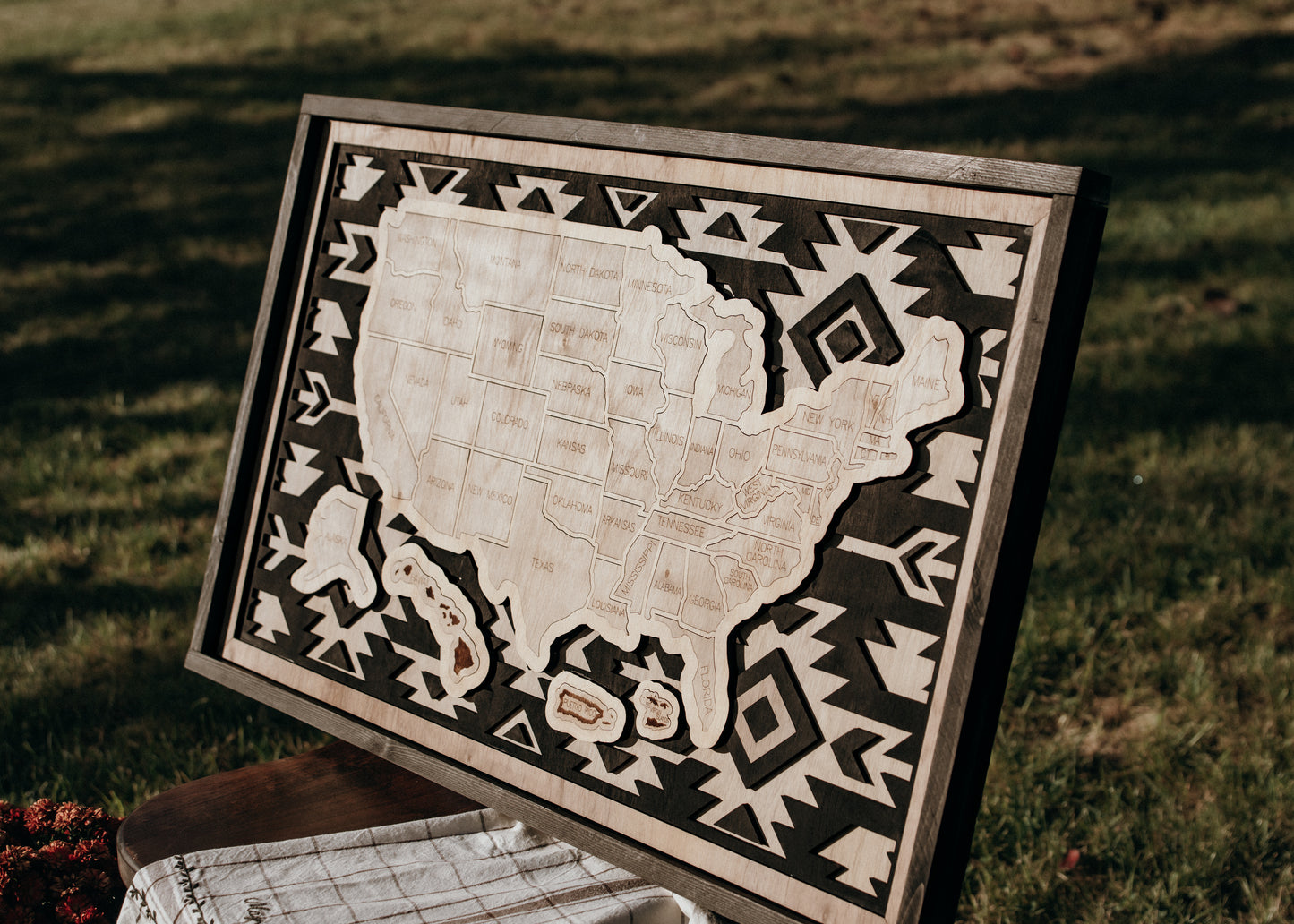 Angled view of the Heritage Trails Storyline Series wooden travel map showcasing engraved states and layered geometric border.