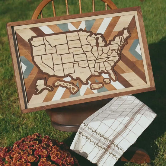 Slow zoom and detail video of the Heritage Quilt wooden travel map, showing handcrafted wood layers, quilt-inspired background, and removable state pieces