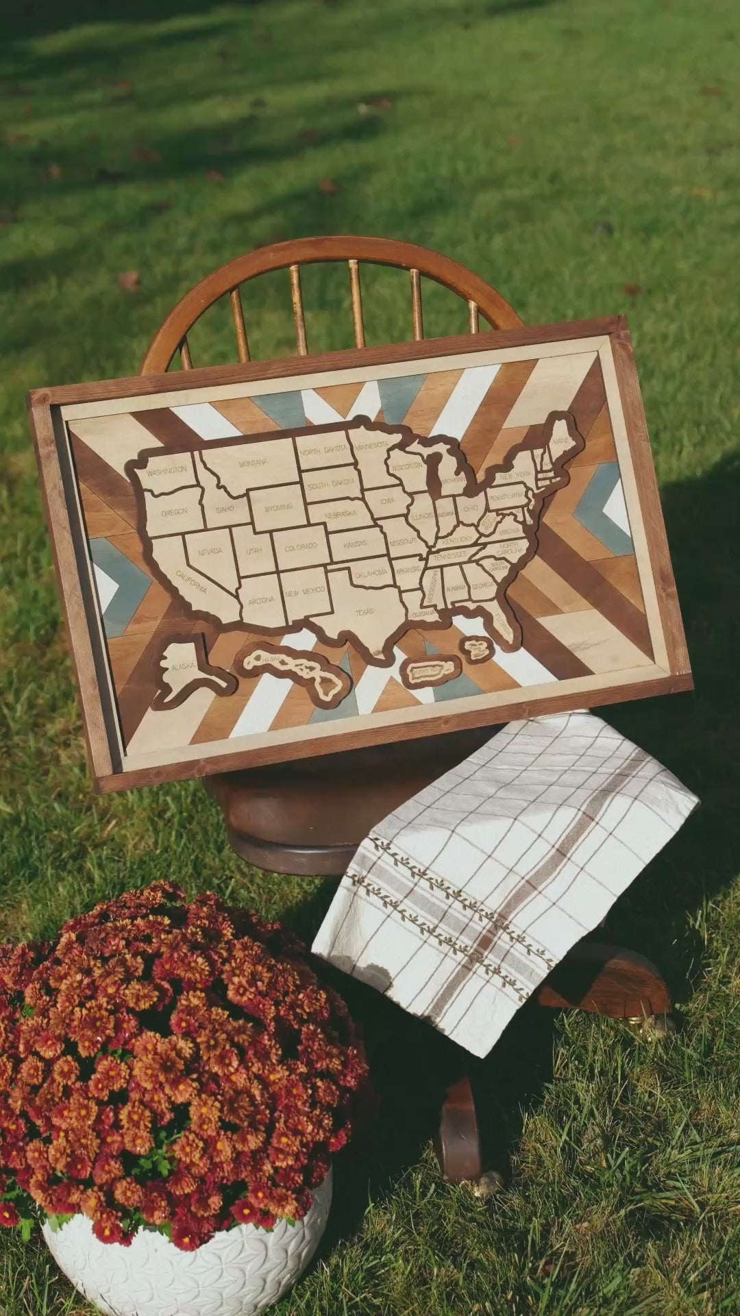 Slow zoom and detail video of the Heritage Quilt wooden travel map, showing handcrafted wood layers, quilt-inspired background, and removable state pieces