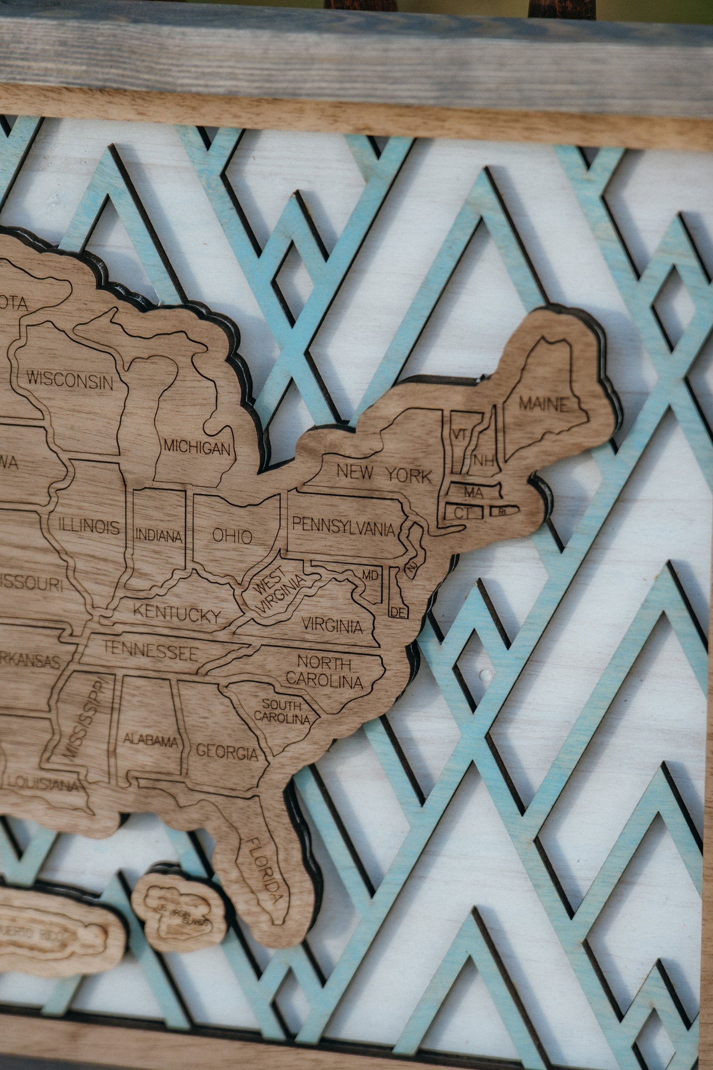 Detailed close-up of engraved state lines and craftsmanship on the Summit Peaks wooden travel map.