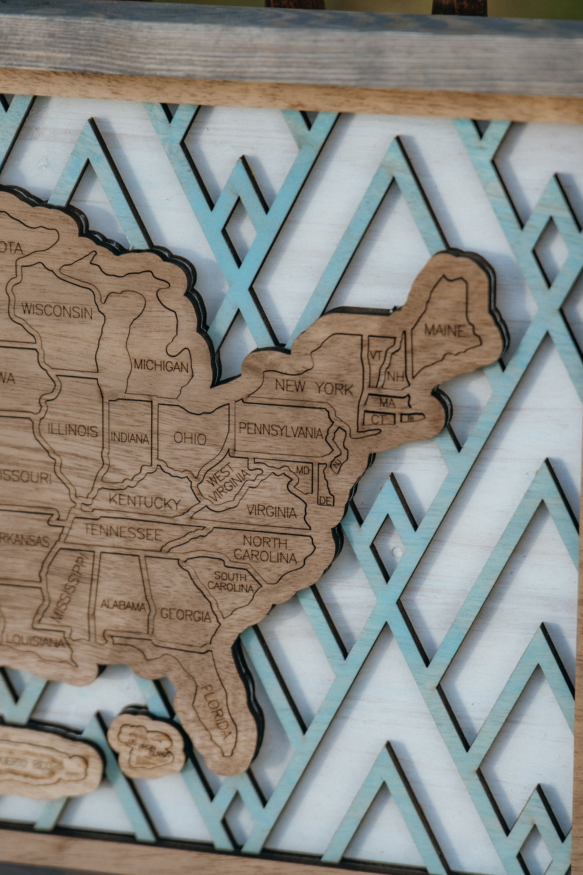 Detailed close-up of engraved state lines and craftsmanship on the Summit Peaks wooden travel map.