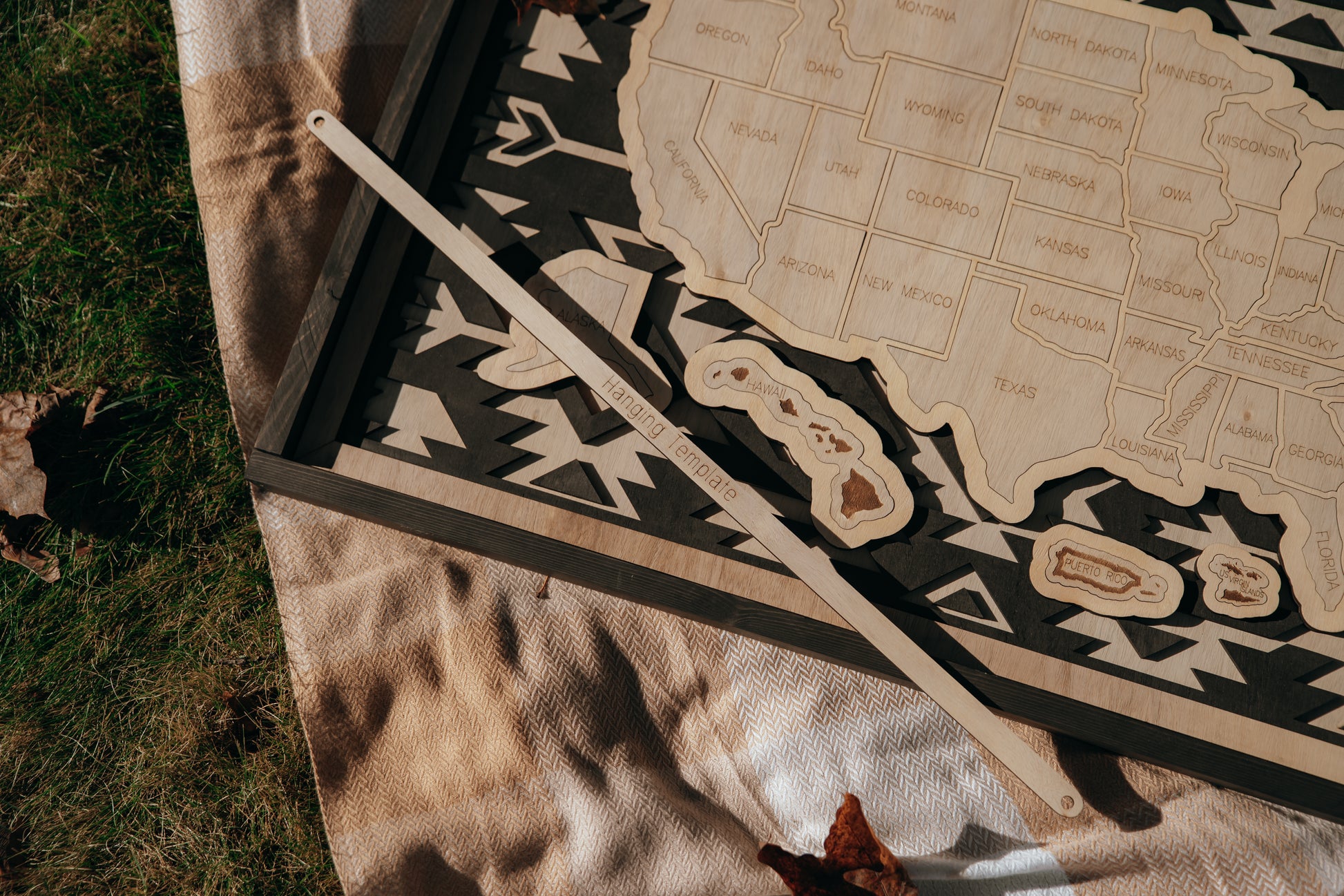 Handcrafted Storyline Series travel map shown with engraved hanging guide, designed to ensure level and accurate wall placement.